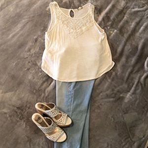 Cream sleeveless blouse with lace detail at top